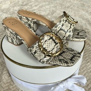 Snakeskin mule heel with gold buckle accent